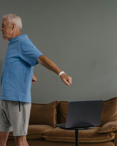 Person doing gentle movement exercises in a bright room